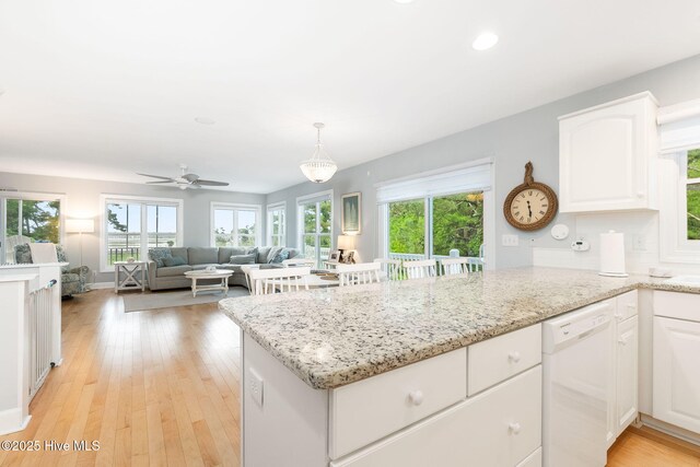 9808 Clarendon Dr, Emerald Isle, NC 28594 - kitchen with dishwasher, a peninsula, white cabinets, plenty of natural light, and recessed lighting