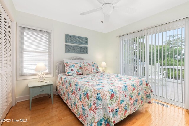 9808 Clarendon Dr, Emerald Isle, NC 28594 - bedroom featuring access to exterior, wood finished floors, multiple windows, and a closet