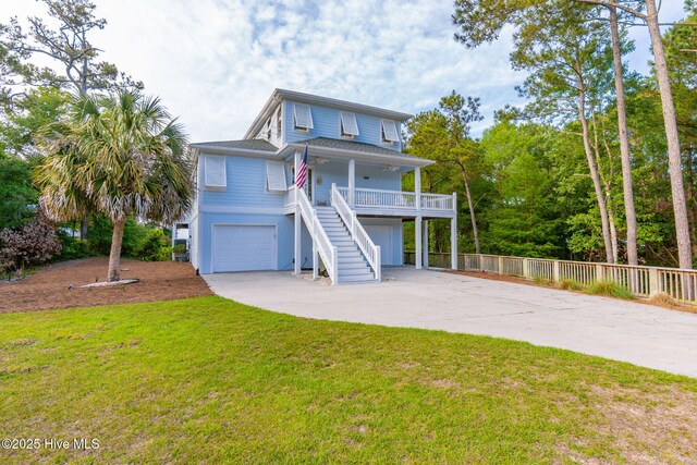 9808 Clarendon Dr, Emerald Isle, NC 28594 - coastal inspired home featuring stairway, an attached garage, driveway, and a porch