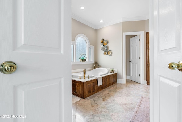 bathroom featuring marble finish floors, ornamental molding, a bath, baseboards, and recessed lighting