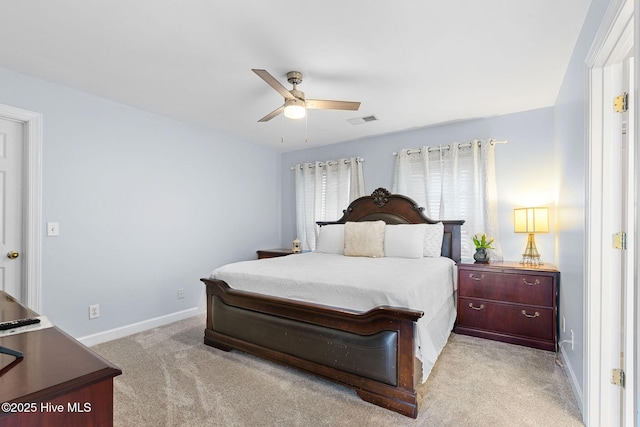 carpeted bedroom featuring baseboards and ceiling fan