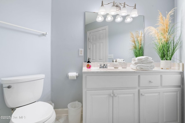half bathroom featuring vanity, toilet, and baseboards