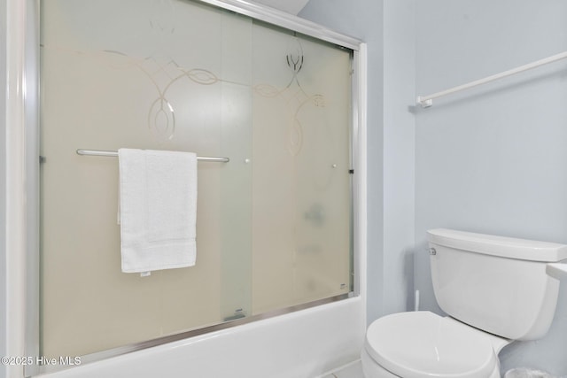 full bathroom with toilet and shower / bath combination with glass door