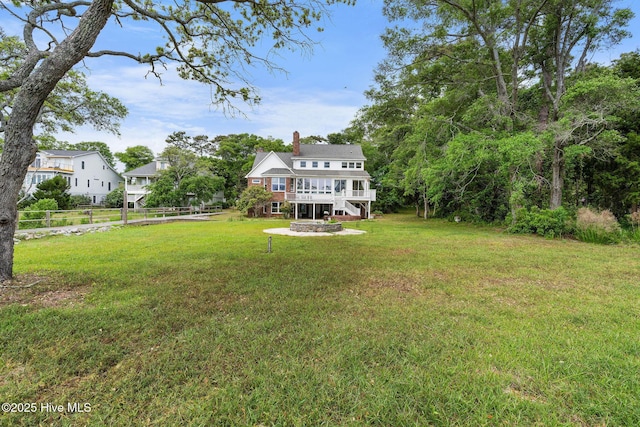 view of yard featuring an outdoor fire pit and a wooden deck