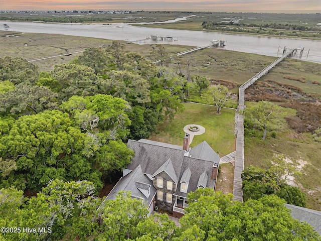 aerial view of property and surrounding area featuring a large body of water