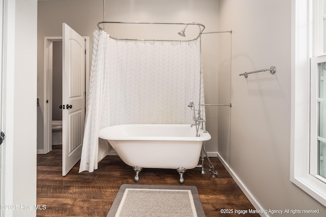 8295 Antioch Church Rd, Middlesex, NC 27557 - bathroom with a freestanding tub, wood finished floors, baseboards, and a shower with shower curtain