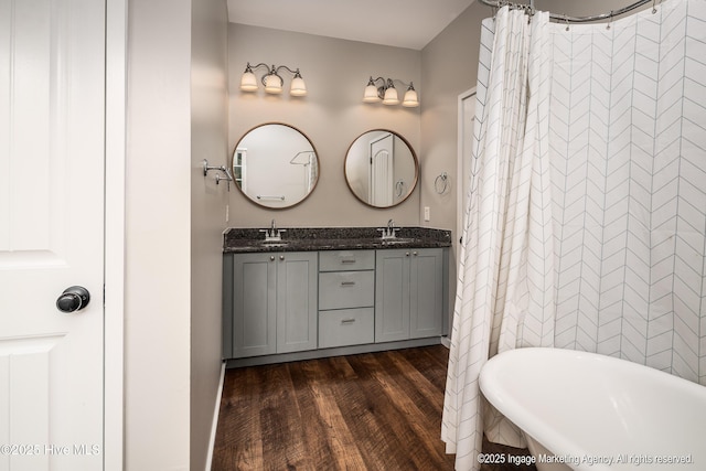 8295 Antioch Church Rd, Middlesex, NC 27557 - bathroom featuring wood finished floors, a freestanding bath, and double vanity