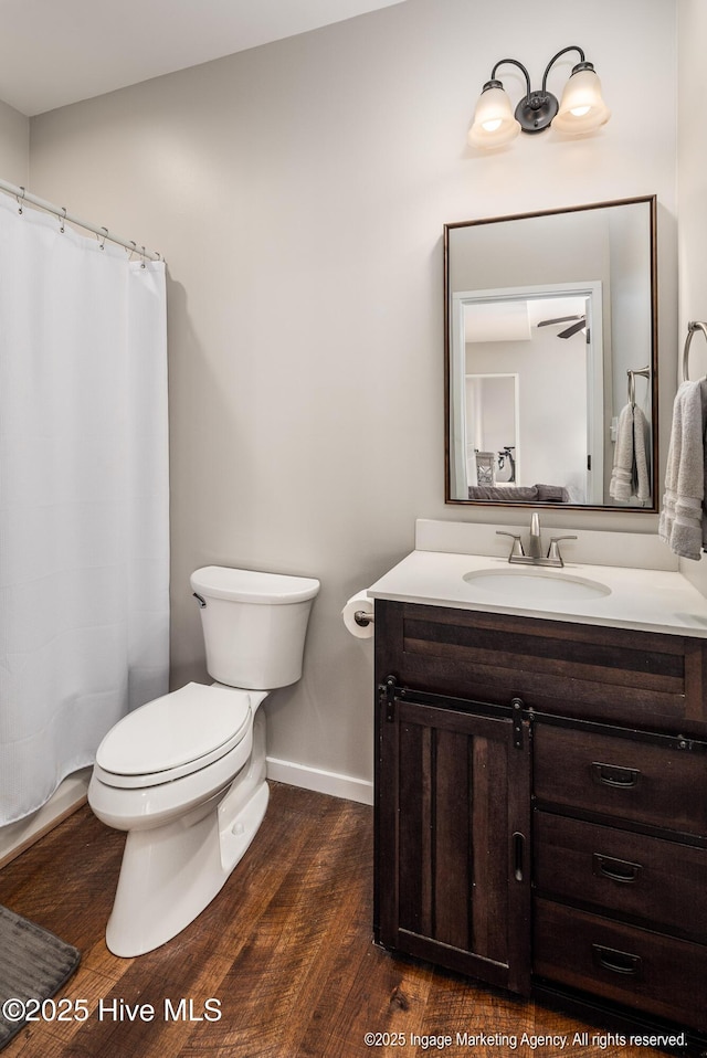 8295 Antioch Church Rd, Middlesex, NC 27557 - bathroom with baseboards, vanity, wood finished floors, toilet, and curtained shower