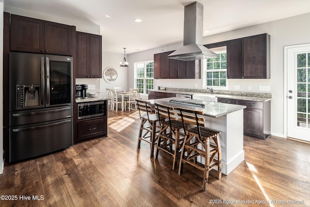 8295 Antioch Church Rd, Middlesex, NC 27557 - kitchen with stainless steel appliances, island range hood, dark wood-style flooring, dark brown cabinets, and a breakfast bar