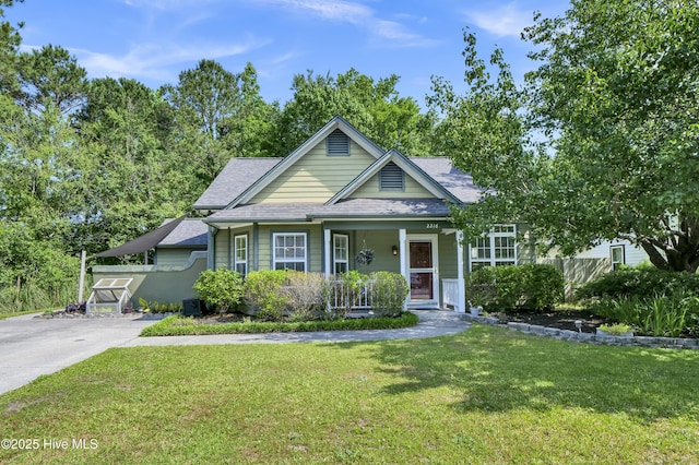 bungalow with a porch and roof with shingles