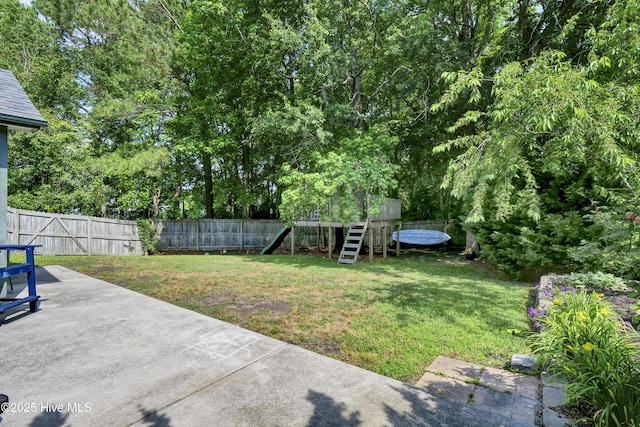 view of yard featuring a patio area and a playground