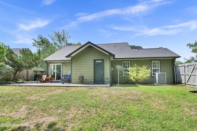 rear view of property featuring central AC, a patio area, and a shingled roof