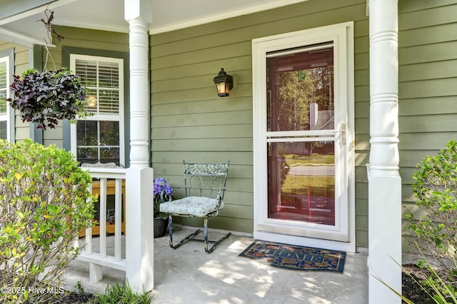 view of exterior entry featuring a porch