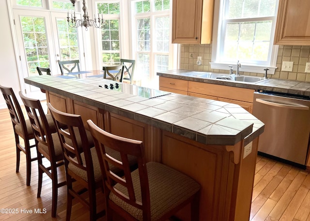 50 Short Rd, Pinehurst, NC 28374 - kitchen with dishwasher, tile countertops, light wood finished floors, a breakfast bar area, and decorative backsplash