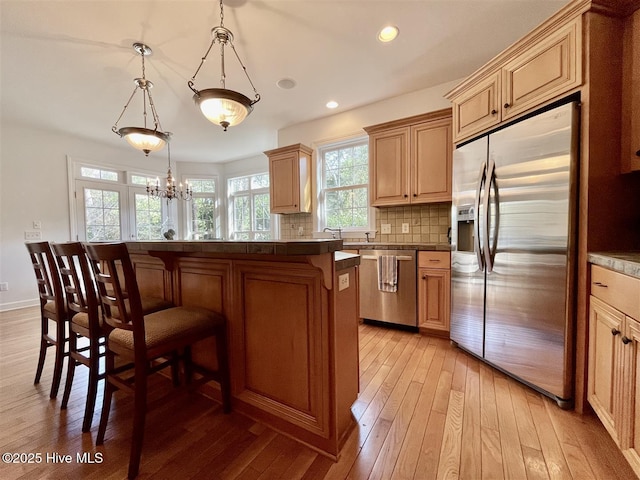 50 Short Rd, Pinehurst, NC 28374 - kitchen featuring stainless steel appliances, a breakfast bar area, light wood-style floors, tasteful backsplash, and recessed lighting