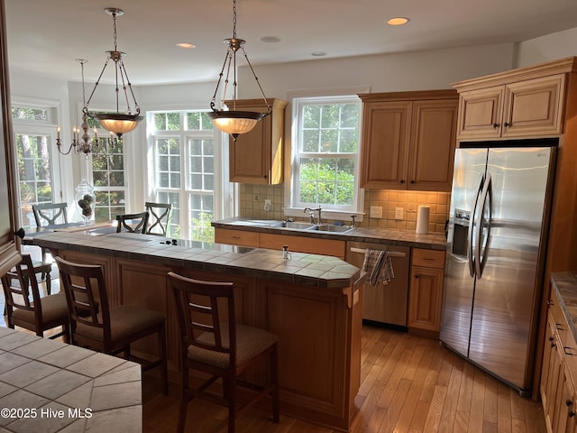 50 Short Rd, Pinehurst, NC 28374 - kitchen featuring stainless steel appliances, tile counters, healthy amount of natural light, a kitchen bar, and recessed lighting