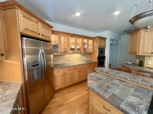 50 Short Rd, Pinehurst, NC 28374 - kitchen with appliances with stainless steel finishes, tasteful backsplash, glass insert cabinets, light wood-style flooring, and recessed lighting