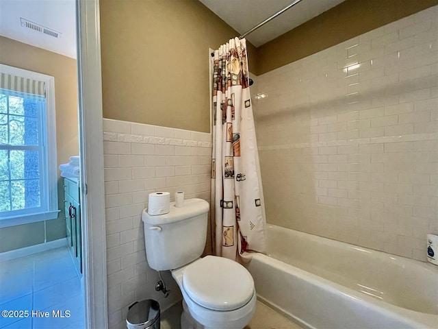 50 Short Rd, Pinehurst, NC 28374 - bathroom featuring shower / bath combo with shower curtain, healthy amount of natural light, tile patterned floors, and tile walls