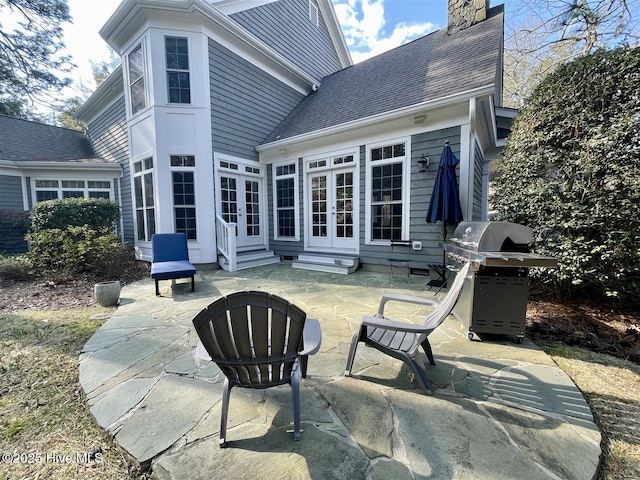 50 Short Rd, Pinehurst, NC 28374 - back of property with french doors, entry steps, a patio, a chimney, and a shingled roof