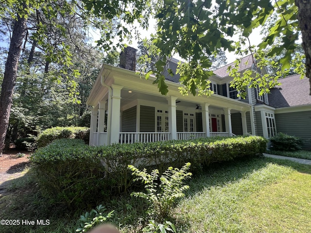 50 Short Rd, Pinehurst, NC 28374 - view of front of home featuring a chimney, covered porch, a front lawn, and a ceiling fan
