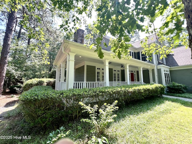 50 Short Rd, Pinehurst, NC 28374 - view of front of home with a chimney, covered porch, a front lawn, and a ceiling fan