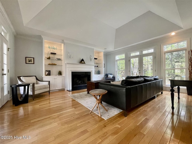 50 Short Rd, Pinehurst, NC 28374 - living room featuring light wood-style floors, crown molding, built in shelves, plenty of natural light, and a tray ceiling