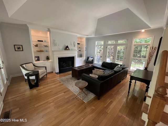 50 Short Rd, Pinehurst, NC 28374 - living room with light wood-style flooring, lofted ceiling, ornamental molding, built in features, and a fireplace with flush hearth