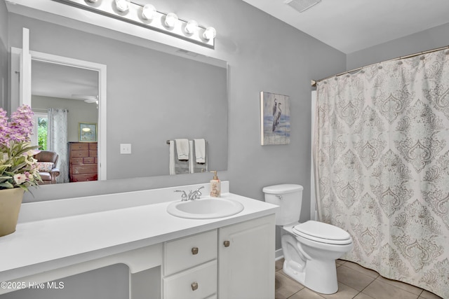full bathroom featuring vanity, tile patterned flooring, toilet, curtained shower, and a ceiling fan