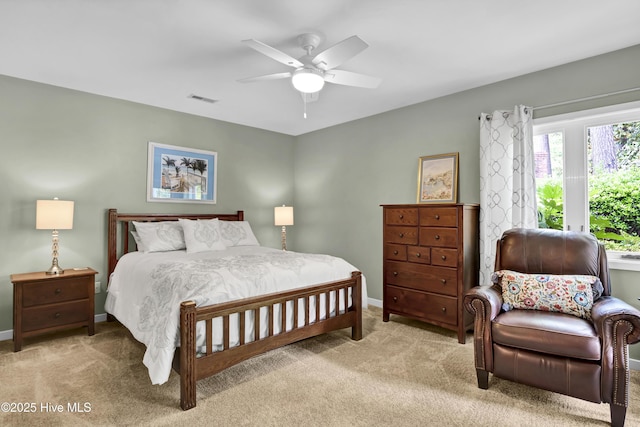 bedroom featuring light carpet, baseboards, and ceiling fan