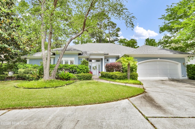 view of front of home featuring concrete driveway, a front lawn, a garage, and roof with shingles