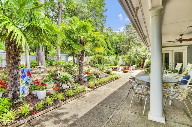 view of patio / terrace featuring outdoor dining area, a fenced backyard, french doors, and a ceiling fan