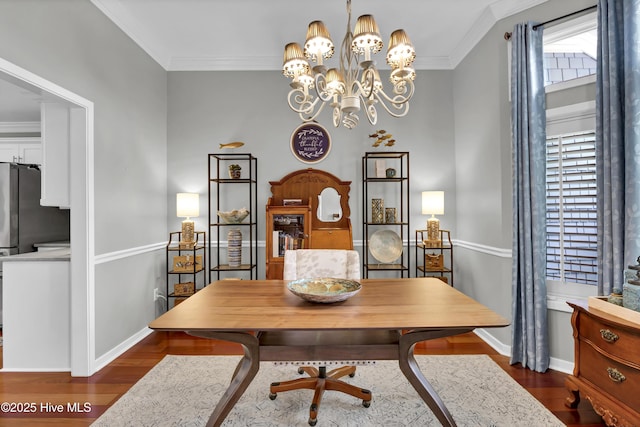dining room featuring baseboards, dark wood-type flooring, crown molding, and a chandelier