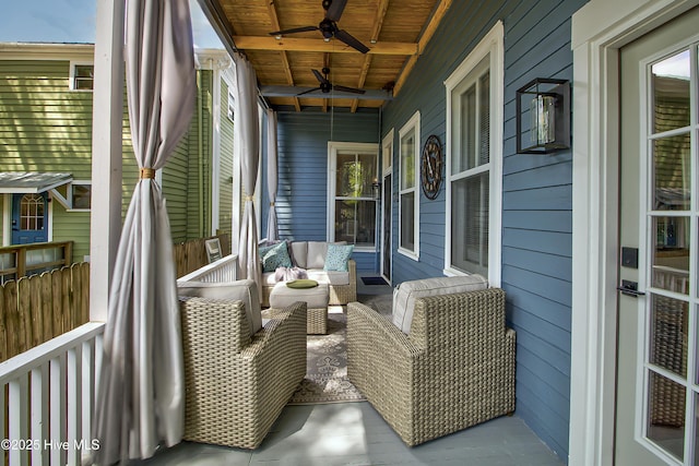 wooden terrace with ceiling fan and an outdoor hangout area