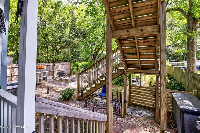 wooden deck featuring stairway and a fenced backyard