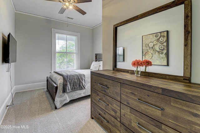 bedroom featuring light colored carpet, baseboards, ornamental molding, and ceiling fan