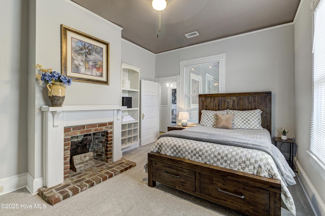 bedroom with carpet flooring, baseboards, ornamental molding, and a fireplace