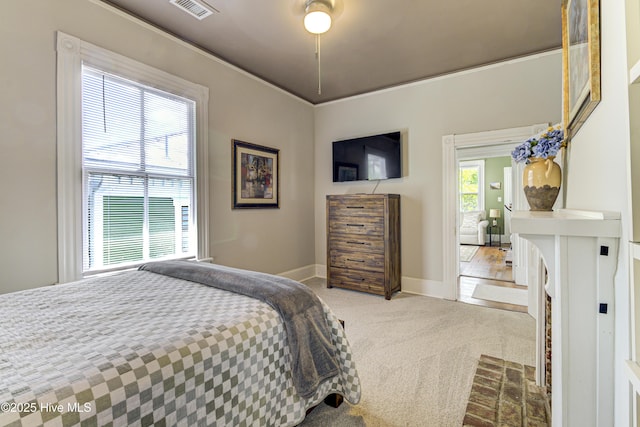 bedroom featuring light colored carpet and baseboards