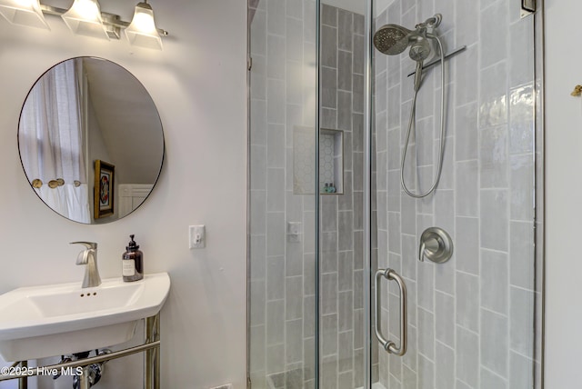full bathroom with a stall shower and a sink