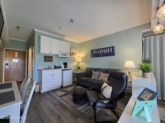 602 W Fort Macon Rd W Unit 138, Atlantic Beach, NC 28512 - living area with dark wood-style floors, crown molding, and a textured ceiling