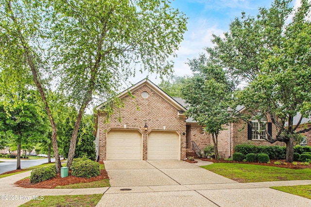 view of front of home featuring driveway, brick siding, and a garage