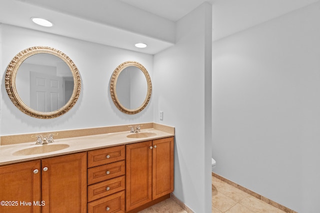 1103 Groppo Cv, Wilmington, NC 28412 - full bathroom featuring toilet, double vanity, tile patterned floors, and baseboards
