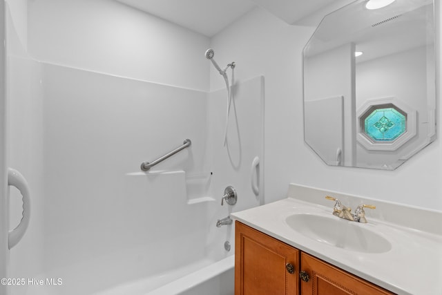 bathroom with vanity and shower / washtub combination