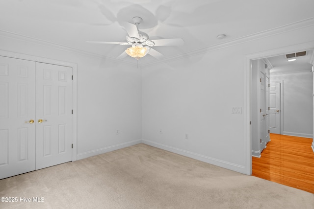 1103 Groppo Cv, Wilmington, NC 28412 - unfurnished bedroom featuring ornamental molding, carpet floors, baseboards, a closet, and a ceiling fan