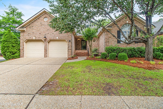 1103 Groppo Cv, Wilmington, NC 28412 - view of front facade with an attached garage, driveway, brick siding, and a front lawn