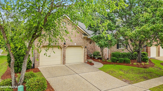 1103 Groppo Cv, Wilmington, NC 28412 - view of front facade with concrete driveway, brick siding, and a shingled roof