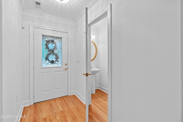 1103 Groppo Cv, Wilmington, NC 28412 - foyer entrance with light wood-style floors, ornamental molding, and baseboards