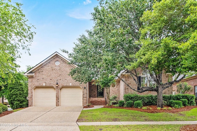 1103 Groppo Cv, Wilmington, NC 28412 - view of front of property with driveway, an attached garage, brick siding, and a front lawn