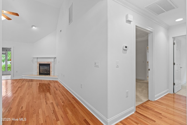 1103 Groppo Cv, Wilmington, NC 28412 - unfurnished living room featuring ceiling fan, light wood-type flooring, baseboards, a fireplace, and ornamental molding