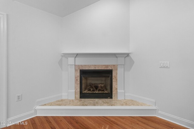 1103 Groppo Cv, Wilmington, NC 28412 - detailed view of wood finished floors, a tiled fireplace, and baseboards