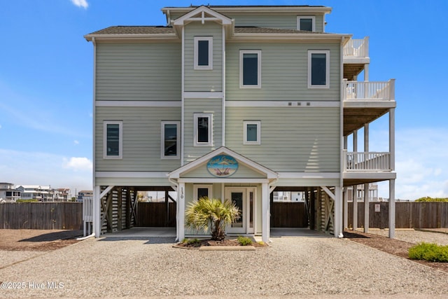 130 N Permuda Wynd Dr, North Topsail Beach, NC 28460 - coastal inspired home featuring driveway, a carport, stairs, and a balcony